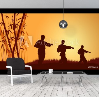 Picture of Three men demonstrate Karate on a background a calling sun